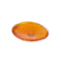 En oval, orange handvärmare som ser ut att vara redo att koka.