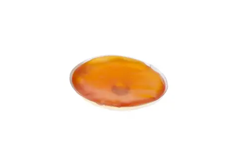 En oval, orange handvärmare som ser ut att vara redo att koka.